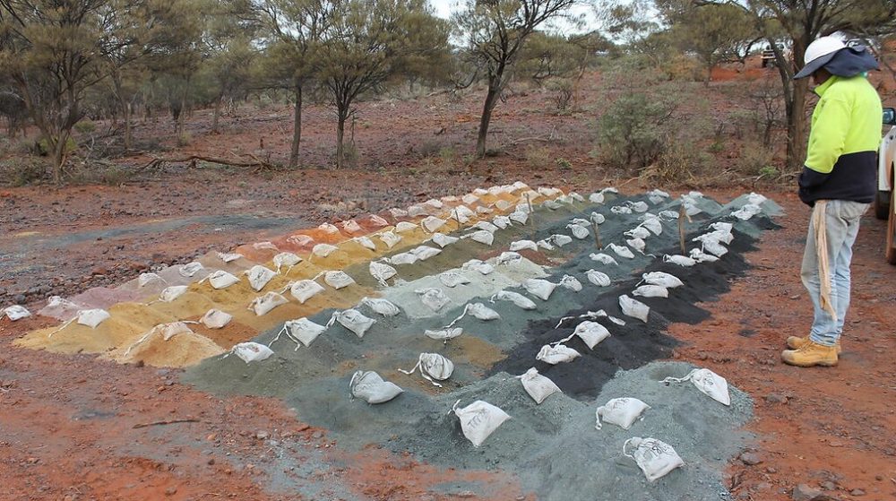 Drill samples laid out in rows by Precision Drilling Australia and bagged at a drilling site for geological logging.